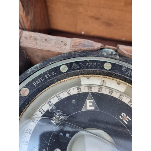 1175 - A ship's gimbal compass, in wood case with broad arrow stamp, 26cm wide.