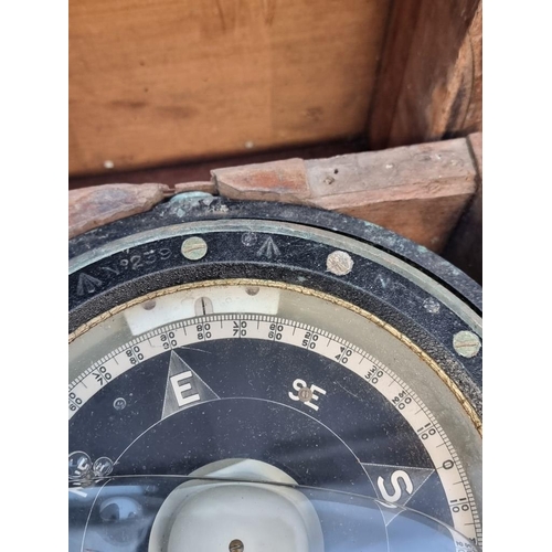 1175 - A ship's gimbal compass, in wood case with broad arrow stamp, 26cm wide.