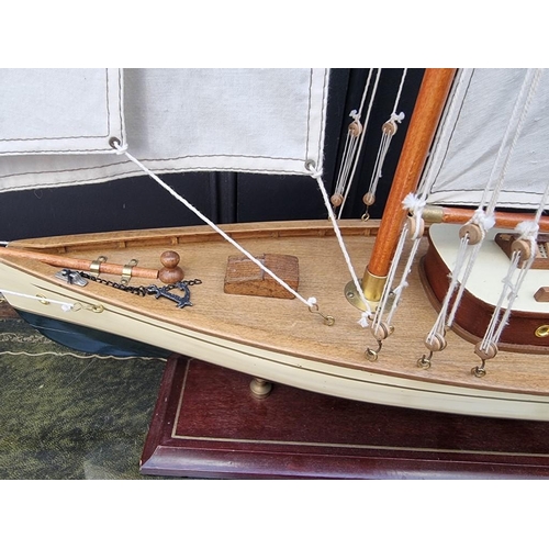 1191 - A painted wood model boat, 90.5cm long, on stand. 