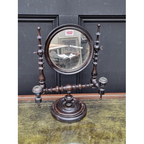 1032 - An antique turned fruitwood shaving mirror, with a pair of candle branches, 40.5cm high.... 