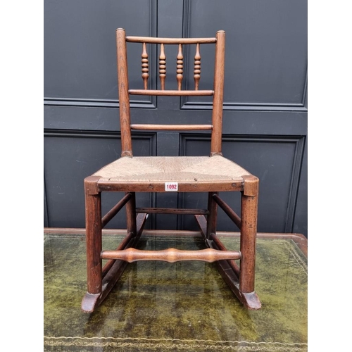 1092 - A small 19th century ash and rush 'Sussex' rocking chair, (probably converted). ... 