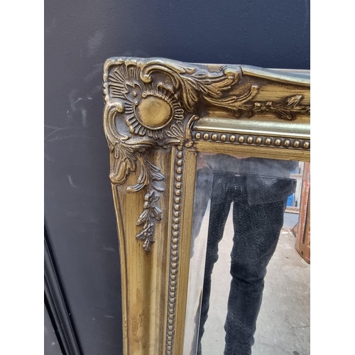 1107 - A reproduction gilt framed rectangular wall mirror, 108 x 75.5cm.