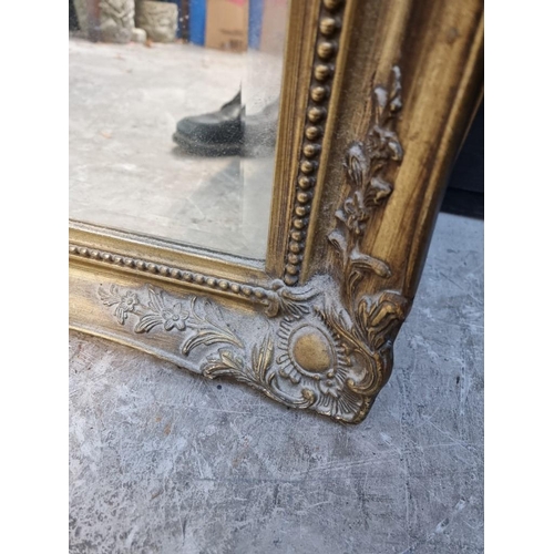 1107 - A reproduction gilt framed rectangular wall mirror, 108 x 75.5cm.