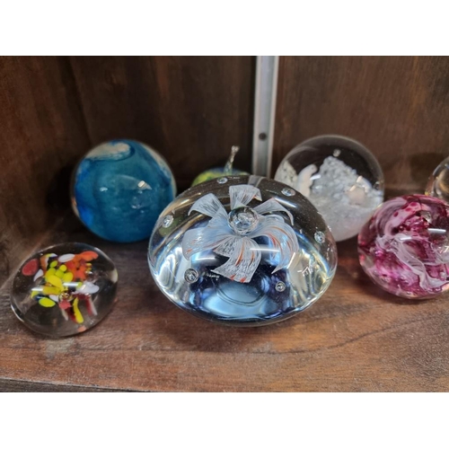 1429 - Seventeen glass paperweights, to include examples by Caithness. (17) 