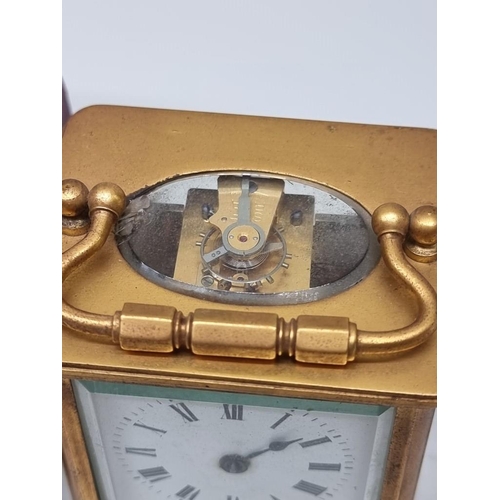 1473 - An antique gilt brass carriage timepiece, height including handle 14cm, (faults), with leather trave... 