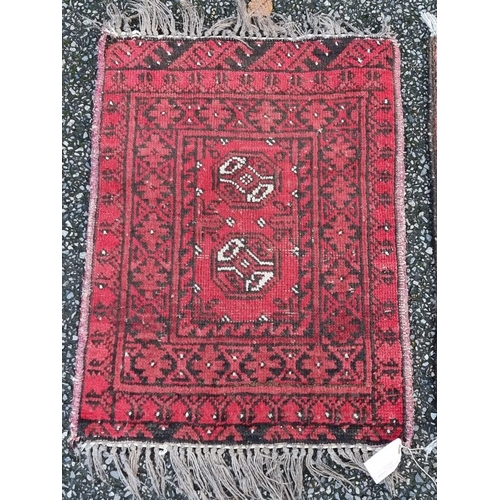 1131 - Four various prayer mats, all on a red ground, largest, 66 x 74cm. 