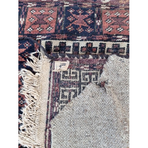 1132 - A pair of Persian rugs, having temple design to central fields, with geometric decoration, 150 x 120... 