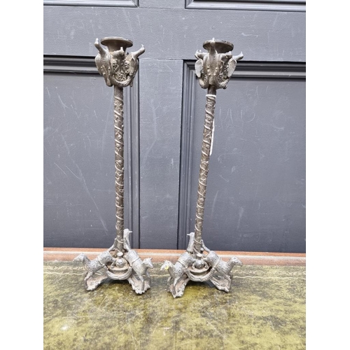 1424 - A pair of bronze tripod candlesticks, 41cm high.