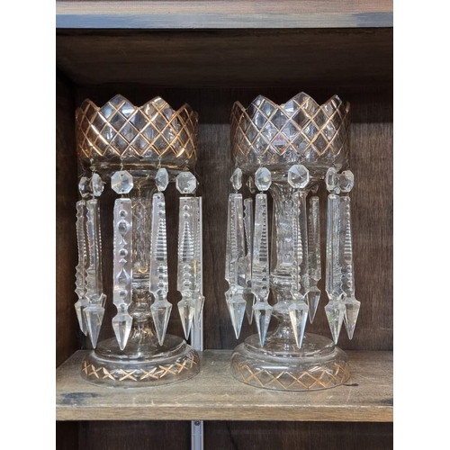 1440 - A pair of clear and gilt glass lustres, 33cm high.