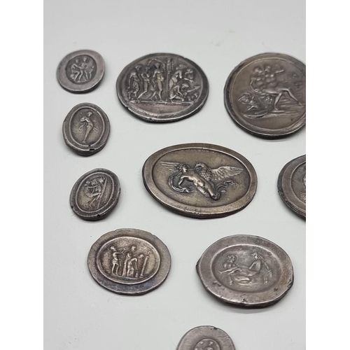 1593 - A collection of thirty unusual Grand Tour style cast metal intaglios, decorated with classical scene... 