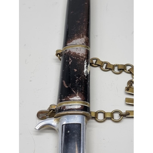 1665 - A World War II Italian model 1937 MVSN officer's dress dagger and scabbard, with brass hanger.... 