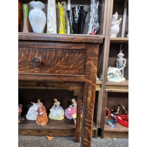 1063 - An Art Deco oak two drawer side table, 64cm wide.