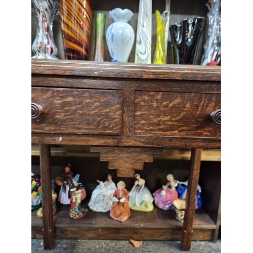 1063 - An Art Deco oak two drawer side table, 64cm wide.