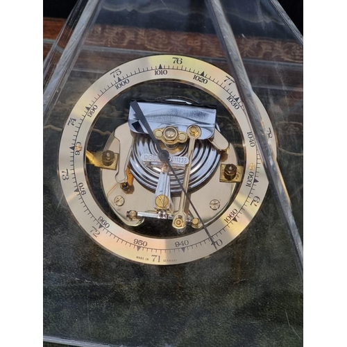 1391 - An aneroid barometer, in perspex pyramid case, 18cm high.