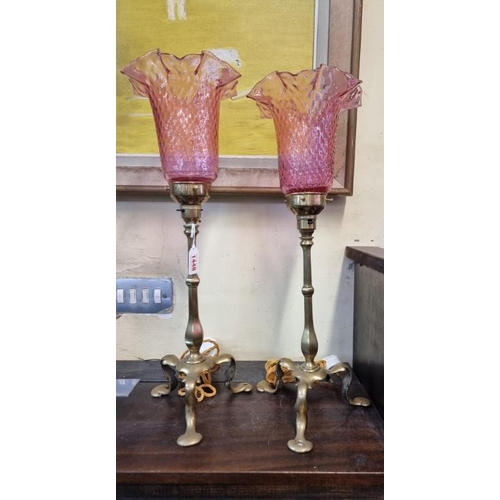 1448 - A pair of antique brass Pullman carriage lamps, with cranberry glass shades, largest 51.5cm hig... 