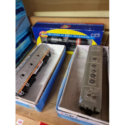 125 - Athearn: a group of twenty-seven boxed H0 gauge coaches and goods wagons.