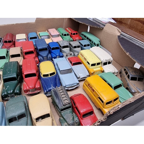 150 - Vintage Diecast: a large group of Dinky vehicles, to include trucks and cars, playworn with som... 