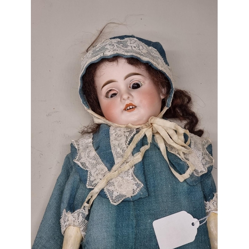 74 - Dolls: an Armand Marseille bisque head baby doll, with blue sleeping eyes and cloth body, (losses to... 