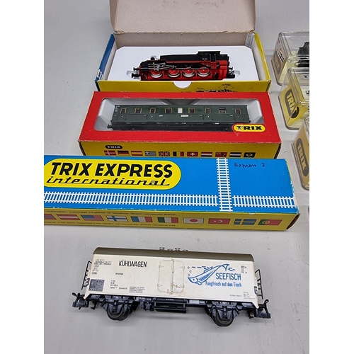 81 - Trix: a small group comprising: a locomotive and coaches, all boxed. (8)