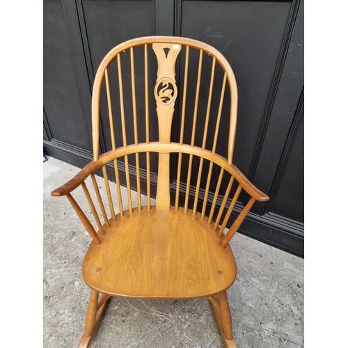 1080 - An Ercol swan back rocking chair. 