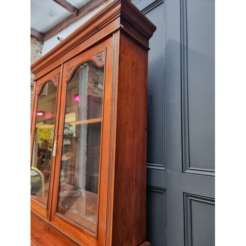 1001 - A late Victorian carved walnut bookcase, 123cm wide