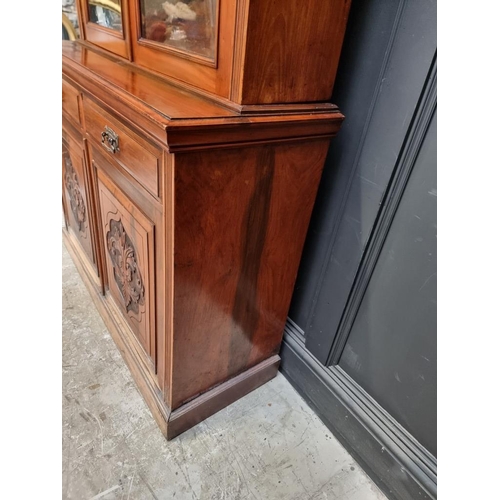 1001 - A late Victorian carved walnut bookcase, 123cm wide