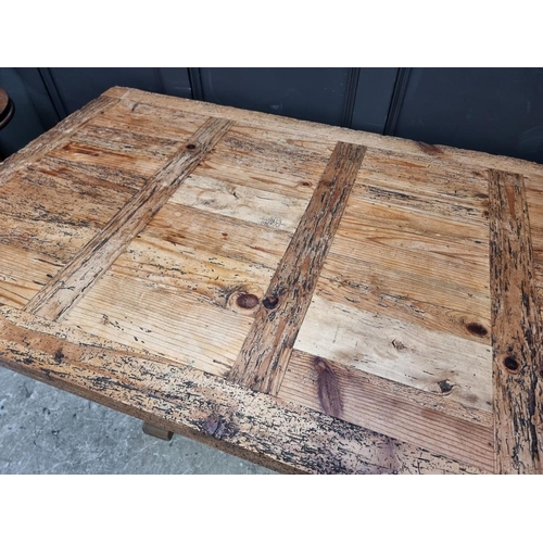 1003 - A distressed pine trestle type table, 160cm long.