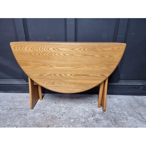 1004 - A modern Ercol pale elm drop leaf dining table, 122cm when open.