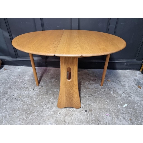 1004 - A modern Ercol pale elm drop leaf dining table, 122cm when open.