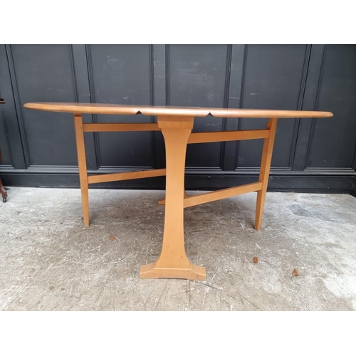 1005 - An Ercol elm drop leaf dining table, 139.5cm when open.