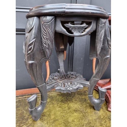 1006 - A small carved and ebonised marble top occasional table, with Elephant supports, 51cm high; together... 