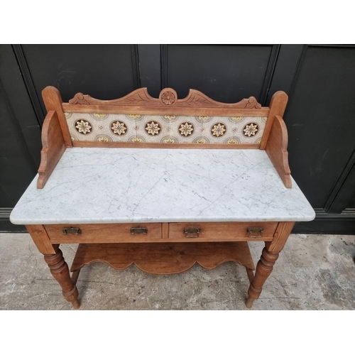 1007 - A late Victorian pine and marble top washstand, with tiled gallery back, 107cm wide.... 