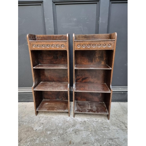 1061 - A small pair of 1920s oak open bookcases, each with frieze drawer, 38cm wide.