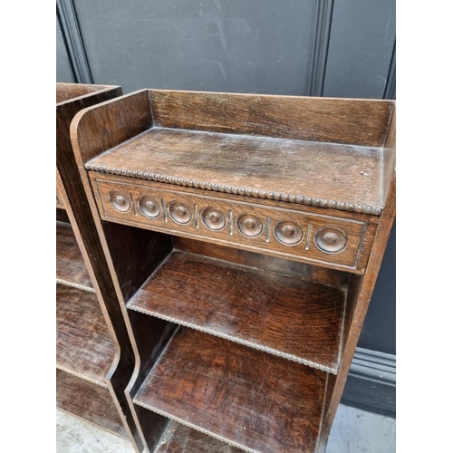 1061 - A small pair of 1920s oak open bookcases, each with frieze drawer, 38cm wide.