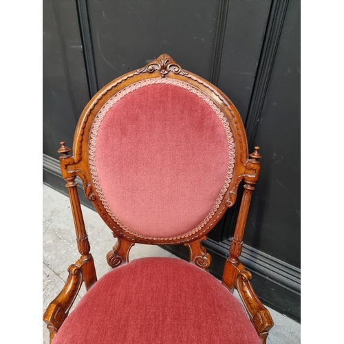 1072 - A Victorian carved walnut and upholstered nursing chair. 