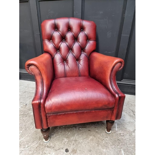 1073 - A reproduction buttoned red leather armchair, by Laura Ashley. ... 