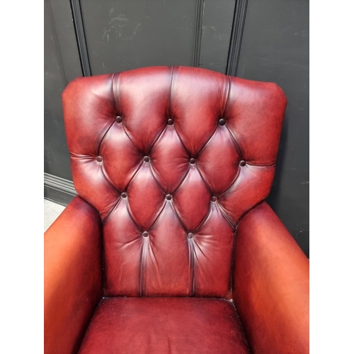 1073 - A reproduction buttoned red leather armchair, by Laura Ashley. ... 