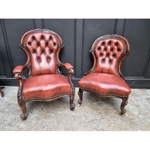 1076 - A pair of Victorian carved walnut and buttoned red leather occasional chairs. 