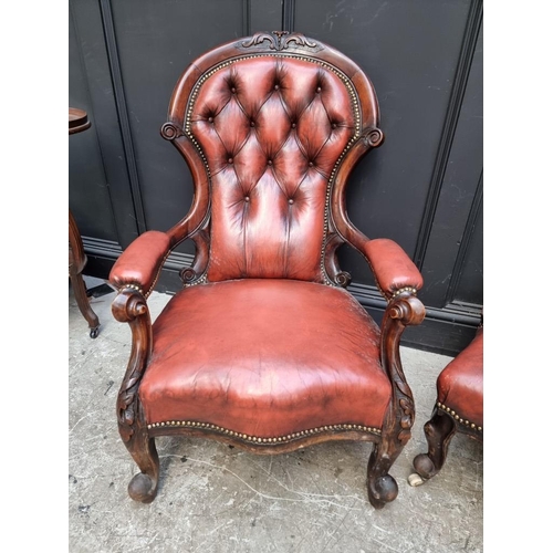 1076 - A pair of Victorian carved walnut and buttoned red leather occasional chairs. 