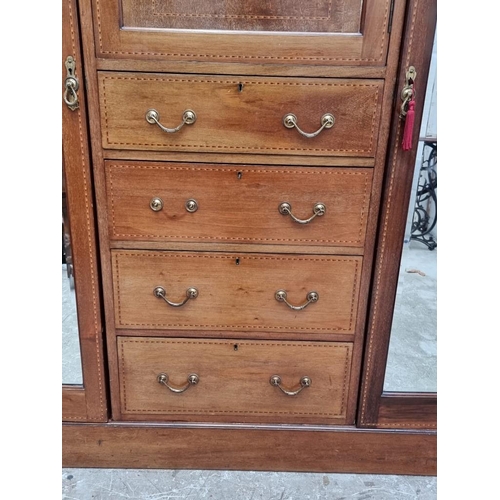 1093 - A late Edwardian mahogany and inlaid triple wardrobe, labelled 'Maple & Co', 190cm wide.... 