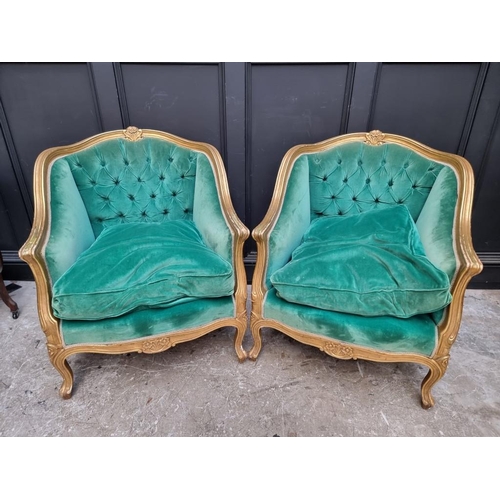 1098 - A large pair of Louis XV style giltwood and button upholstered fauteuils. 