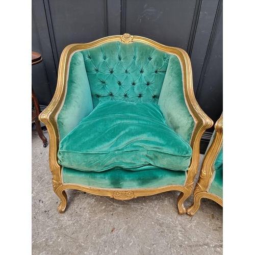 1098 - A large pair of Louis XV style giltwood and button upholstered fauteuils. 