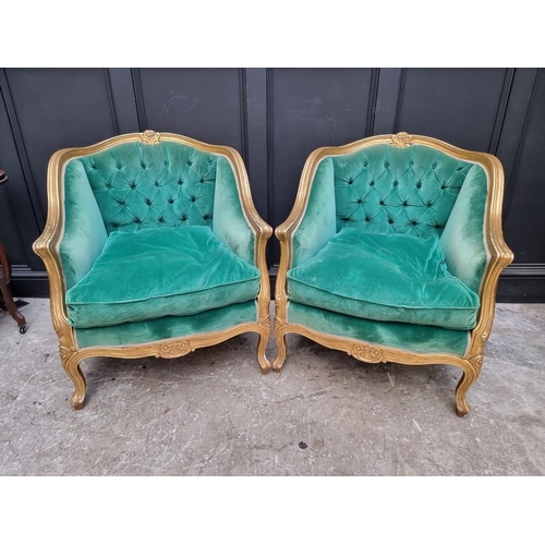 1098 - A large pair of Louis XV style giltwood and button upholstered fauteuils. 