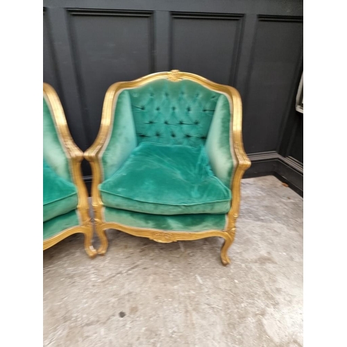 1098 - A large pair of Louis XV style giltwood and button upholstered fauteuils. 