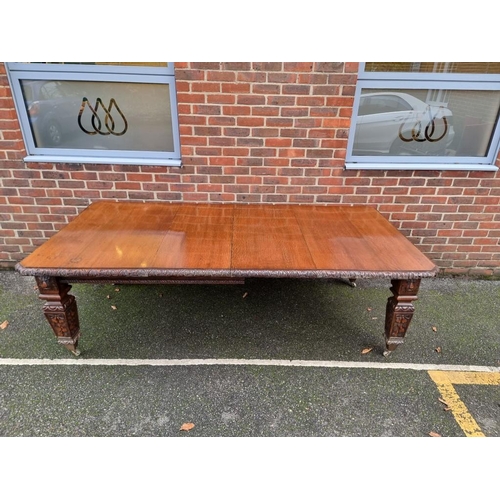 1111 - A Victorian carved oak extending dining table, with two leaf insertions, 235cm extended.... 