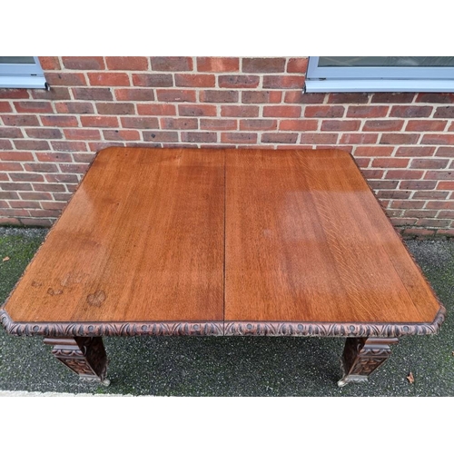 1111 - A Victorian carved oak extending dining table, with two leaf insertions, 235cm extended.... 