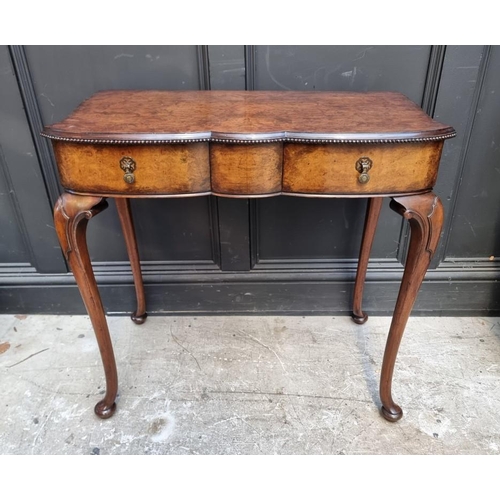 1114 - A 1920s burr walnut side table, of shaped outline, 75.5cm wide.