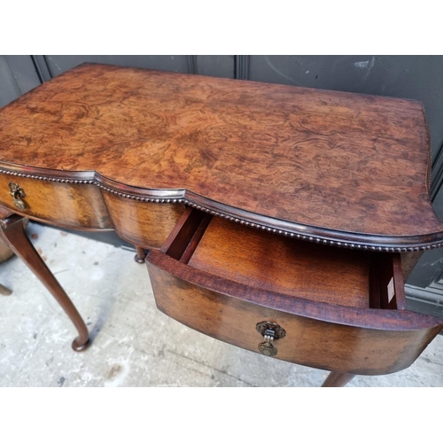 1114 - A 1920s burr walnut side table, of shaped outline, 75.5cm wide.