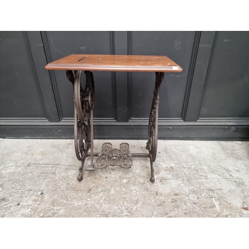 1134 - A late 19th century Willcox & Gibbs cast iron sewing machine base, 63cm wide.... 