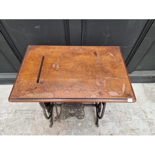 1134 - A late 19th century Willcox & Gibbs cast iron sewing machine base, 63cm wide.... 